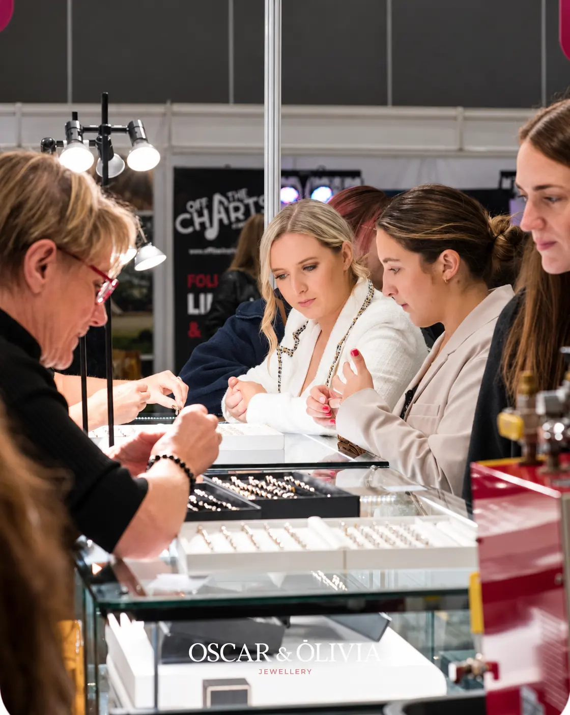 The Oscar and Olivia team helping customers explore jewellery at a wedding show